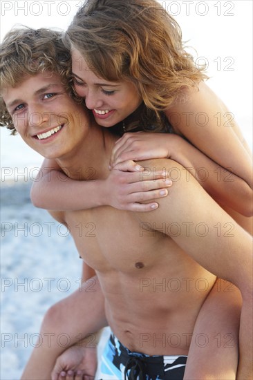 Young man carrying girlfriend on back. Date : 2008