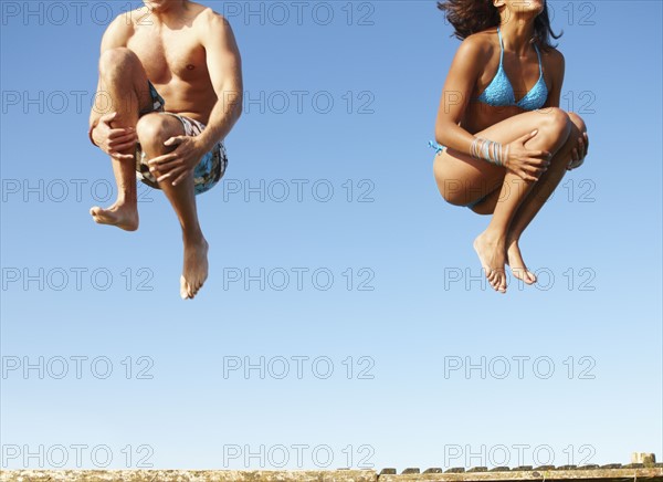 Young couple jumping of dock. Date : 2008