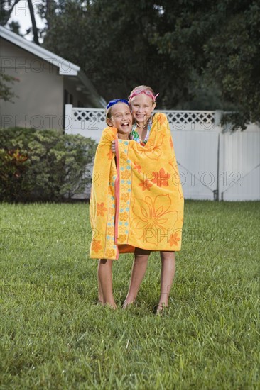 Girls wrapped in towels on lawn. Date : 2008