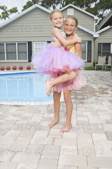 Girls in tutus playing by swimming pool. Date : 2008