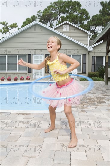 Girl in tutu hula hooping. Date : 2008