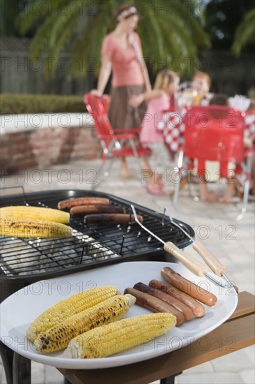 Grilled hotdogs and corn on backyard grill. Date : 2008