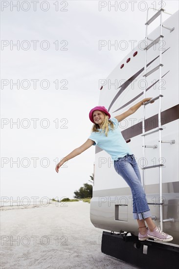 Girl climbing on motor home ladder. Date : 2008