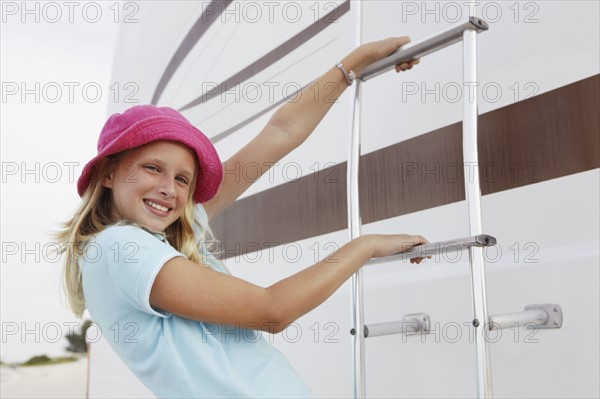 Girl climbing on motor home ladder. Date : 2008