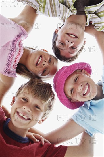 Low angle view of children in a huddle. Date : 2008