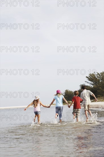 Children running in ocean. Date : 2008