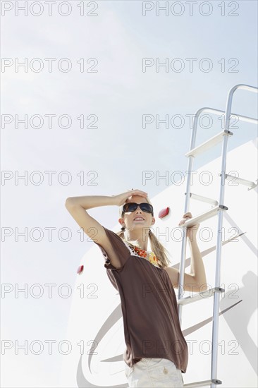 Young woman climbing motor home ladder. Date : 2008