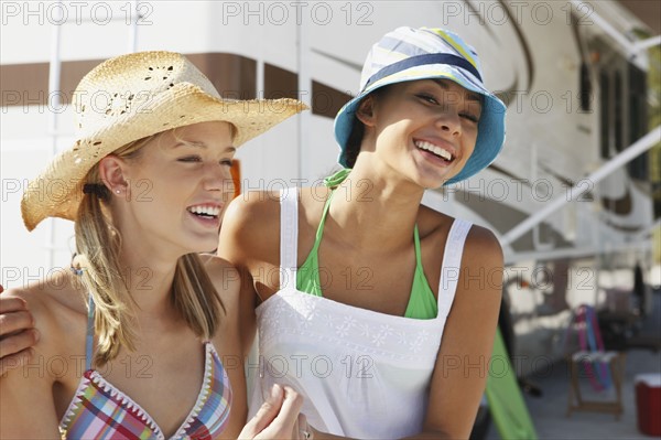 Friends laughing near motor home on beach. Date : 2008