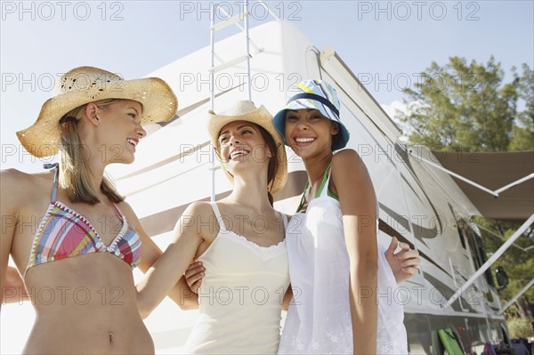 Friends laughing near motor home on beach. Date : 2008