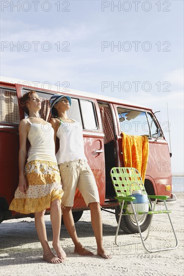 Young women leaning on van. Date : 2008