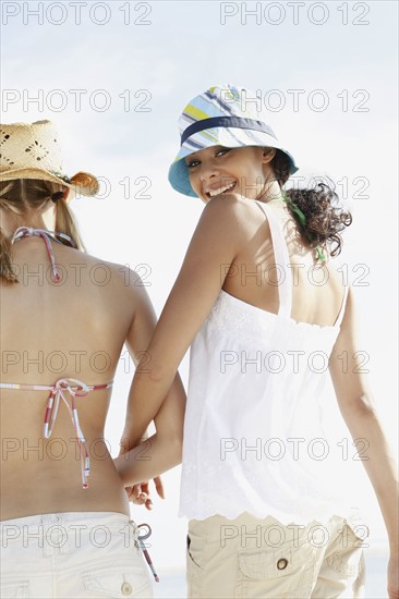 Friends walking on beach. Date : 2008