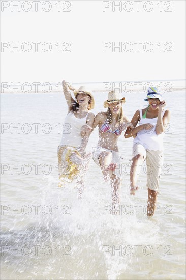 Friends splashing in ocean. Date : 2008