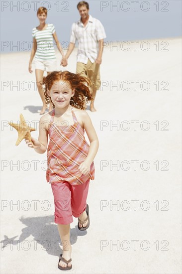 Family walking together on beach. Date : 2008