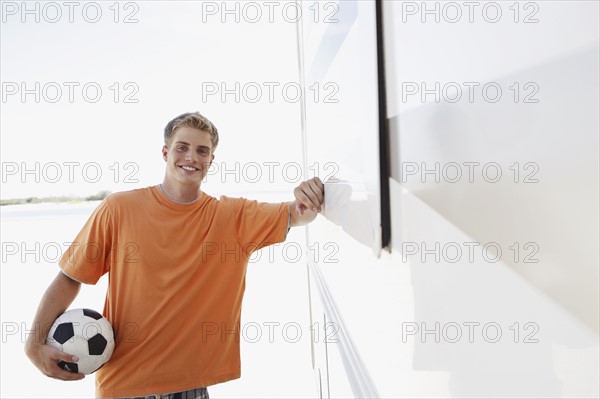 Young man leaning against motor home. Date : 2008