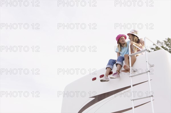 Girls sitting on top of motor home. Date : 2008