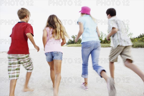 Children running on beach. Date : 2008