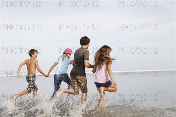 Children running in ocean. Date : 2008