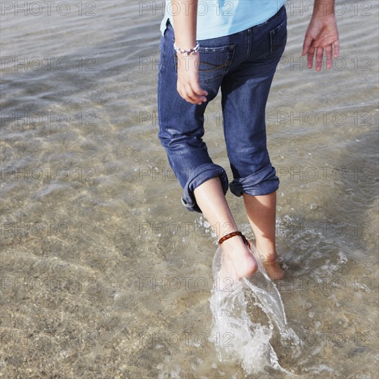 Girl wading in ocean. Date : 2008