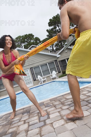 Couple playing tug-of-war with towel. Date : 2008