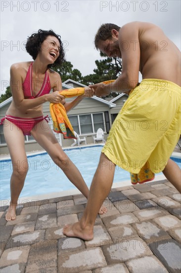 Couple playing tug-of-war with towel. Date : 2008