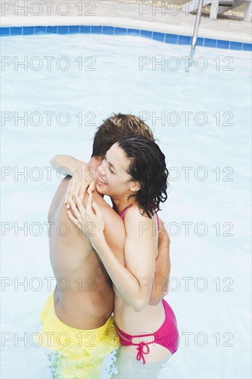 Couple hugging in swimming pool. Date : 2008