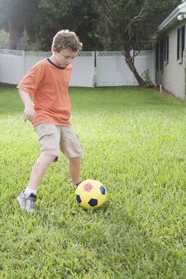 Boy playing in soccer in backyard. Date : 2008