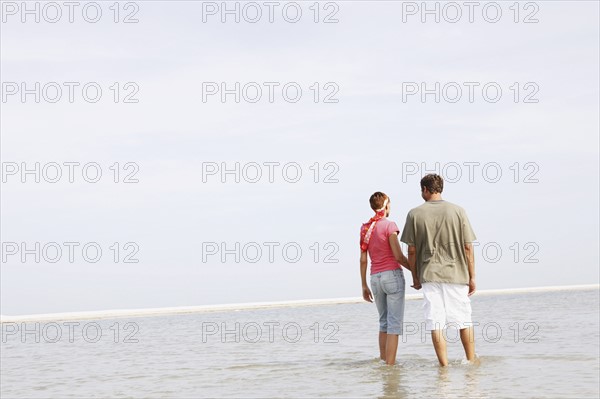 Couple wading in ocean. Date : 2008