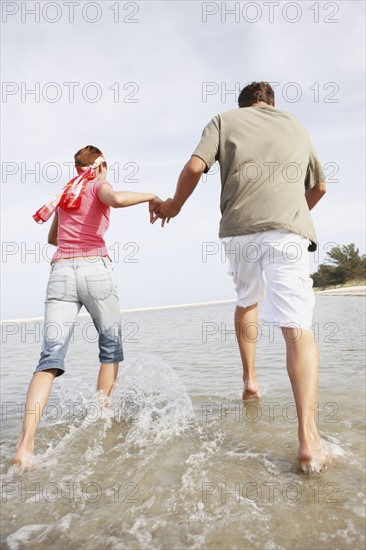 Couple running in ocean. Date : 2008