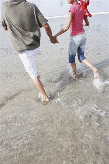 Couple running in ocean. Date : 2008