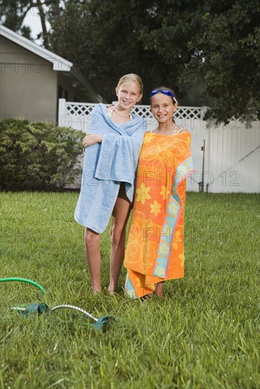Girls wrapped in towels on lawn. Date : 2008