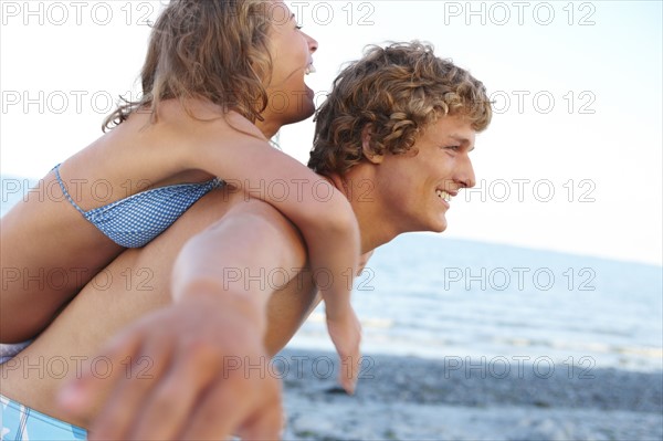 Young man carrying girlfriend on back. Date : 2008