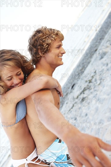 Young man carrying girlfriend on back. Date : 2008