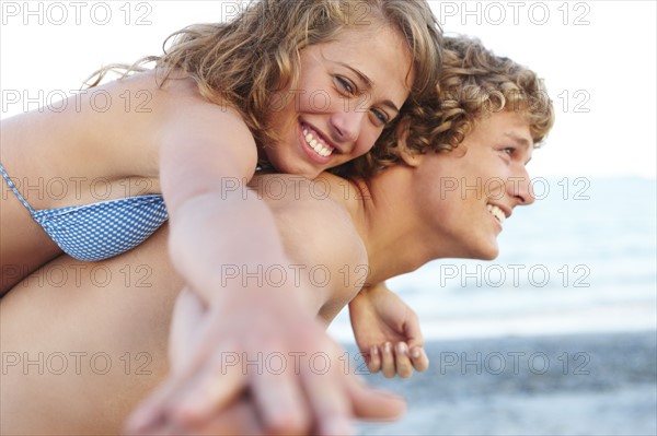 Young man carrying girlfriend on back. Date : 2008