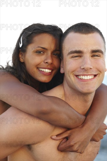 Young man carrying girlfriend on back. Date : 2008