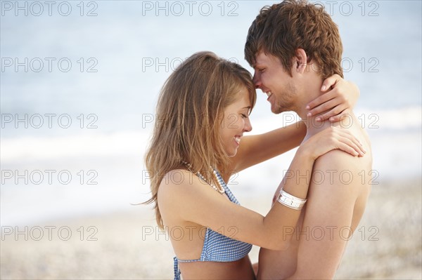 Young couple hugging on beach. Date : 2008