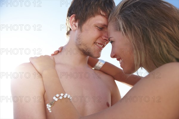 Young couple hugging on beach. Date : 2008