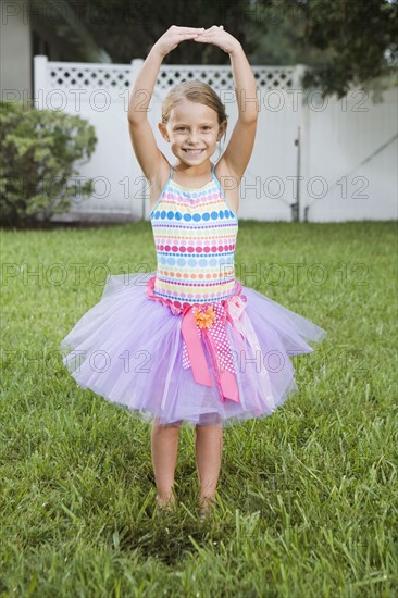 Girl in tutu posing on lawn. Date : 2008