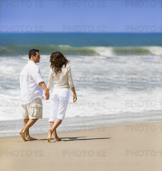 Couple walking on beach. Date : 2008