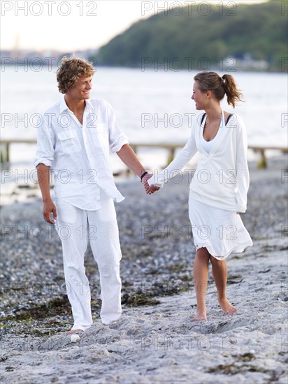 Young couple walking on beach. Date : 2008