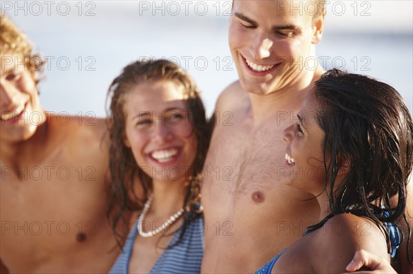 Young couples smiling on beach. Date : 2008