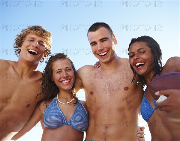 Young couples laughing on beach. Date : 2008