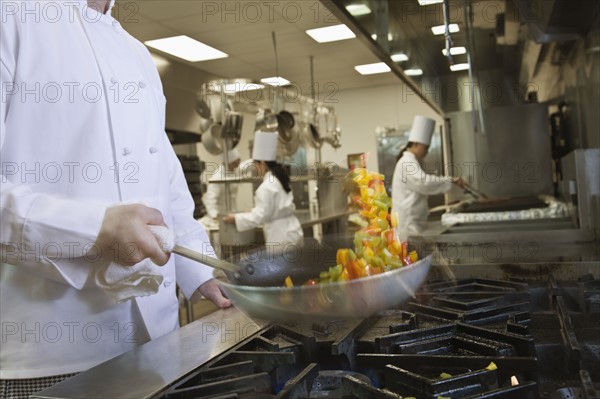 Chef tossing food in skillet. Date : 2008