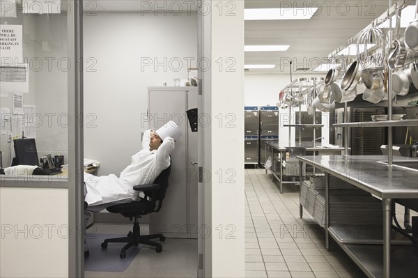 Chef relaxing in kitchen office. Date : 2008