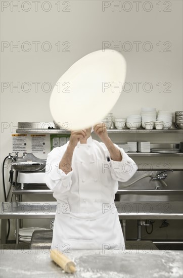 Chef tossing pizza dough. Date : 2008