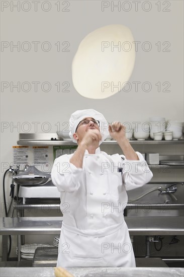 Chef tossing pizza dough. Date : 2008