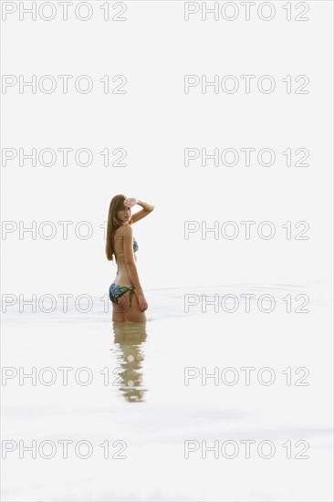 Teenage girl wading in ocean. Date : 2008