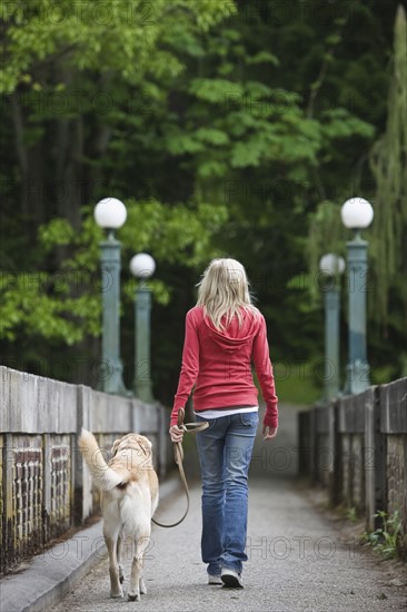 Girl walking dog across bridge. Date : 2008