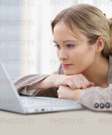 Businesswoman looking at laptop. Date : 2008