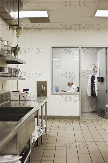 Chef sitting in kitchen office. Date : 2008