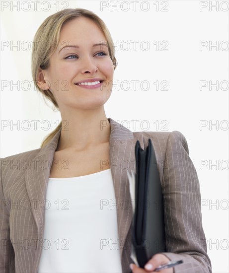 Portrait of businesswoman holding file. Date : 2008